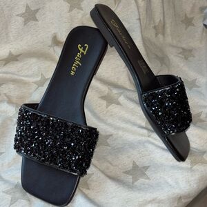 Black beautiful 😍 sandals with black stones is under statement size 39 so 8 us